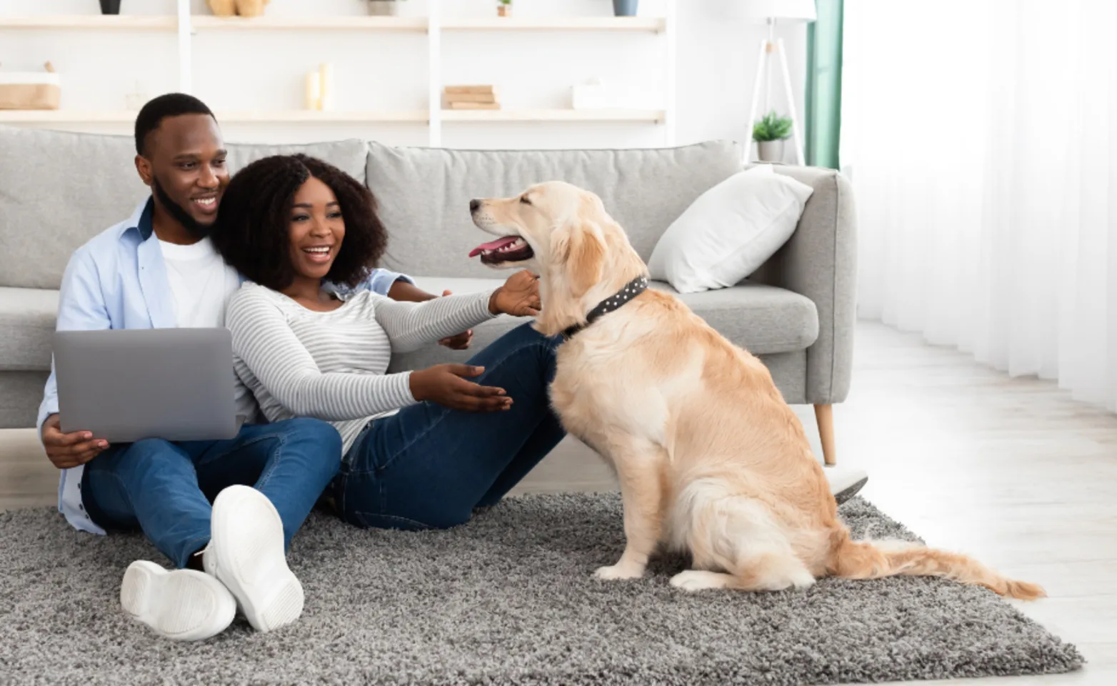 A Couple with Laptop and Dog at Home