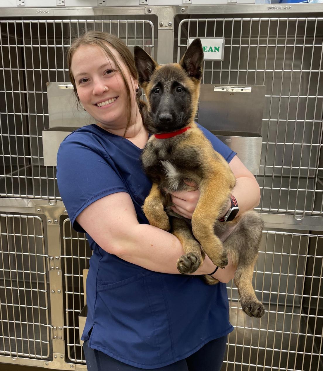 Jess B. holding a small German Shepherd 