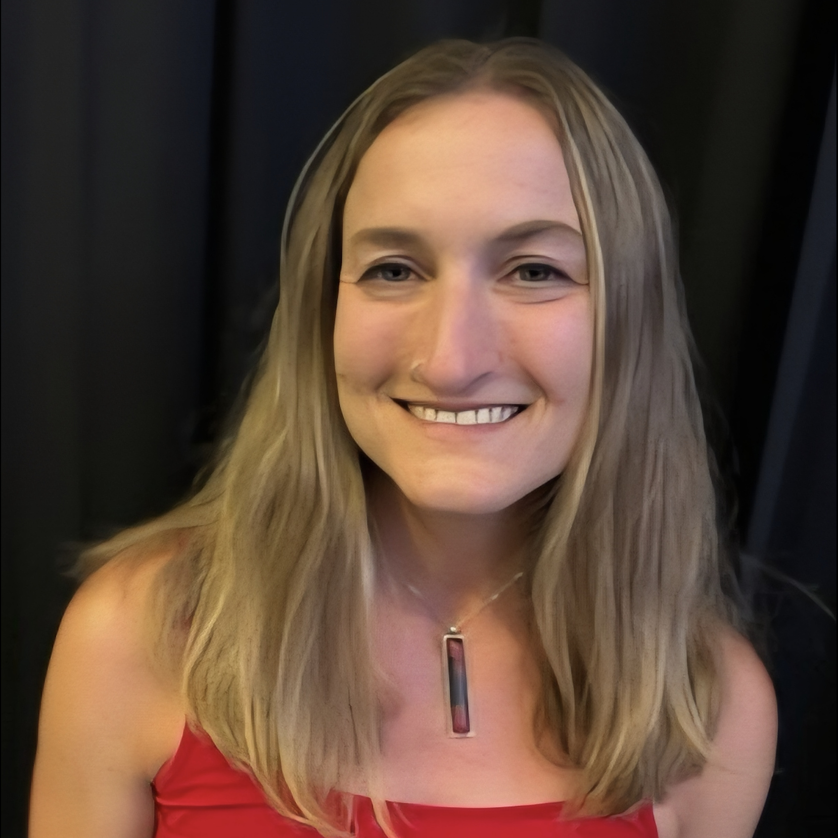 Anna Brown headshot in a red shirt