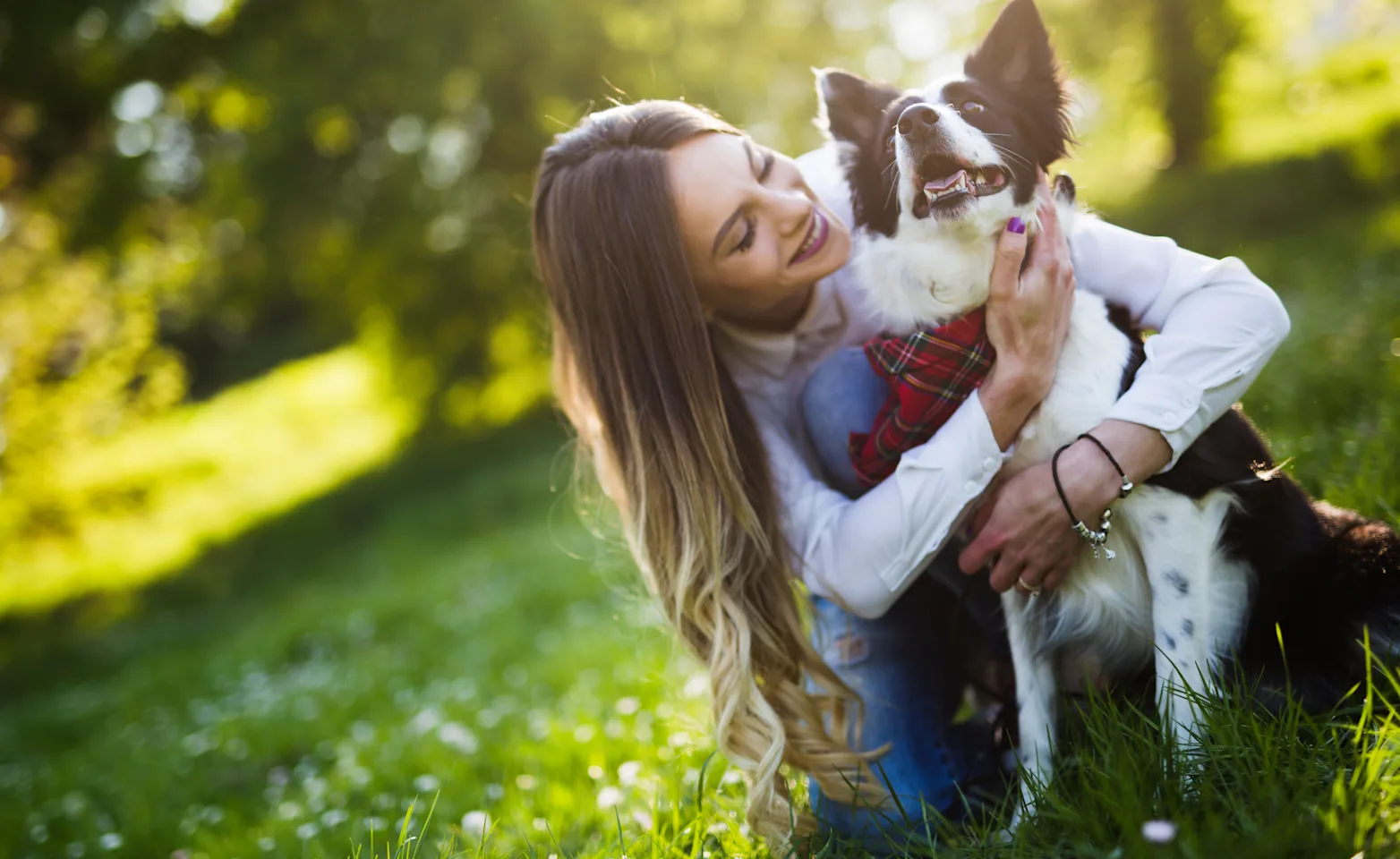 woman holding dog at park