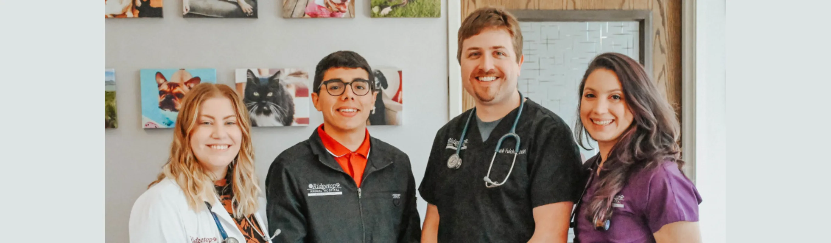 Four of Ridgetop Animal Hospital's DVMs posing in front of a wall of animal pictures Four of Ridgetop Animal Hospital's DVMs posing in front of a wall of animal pictures
