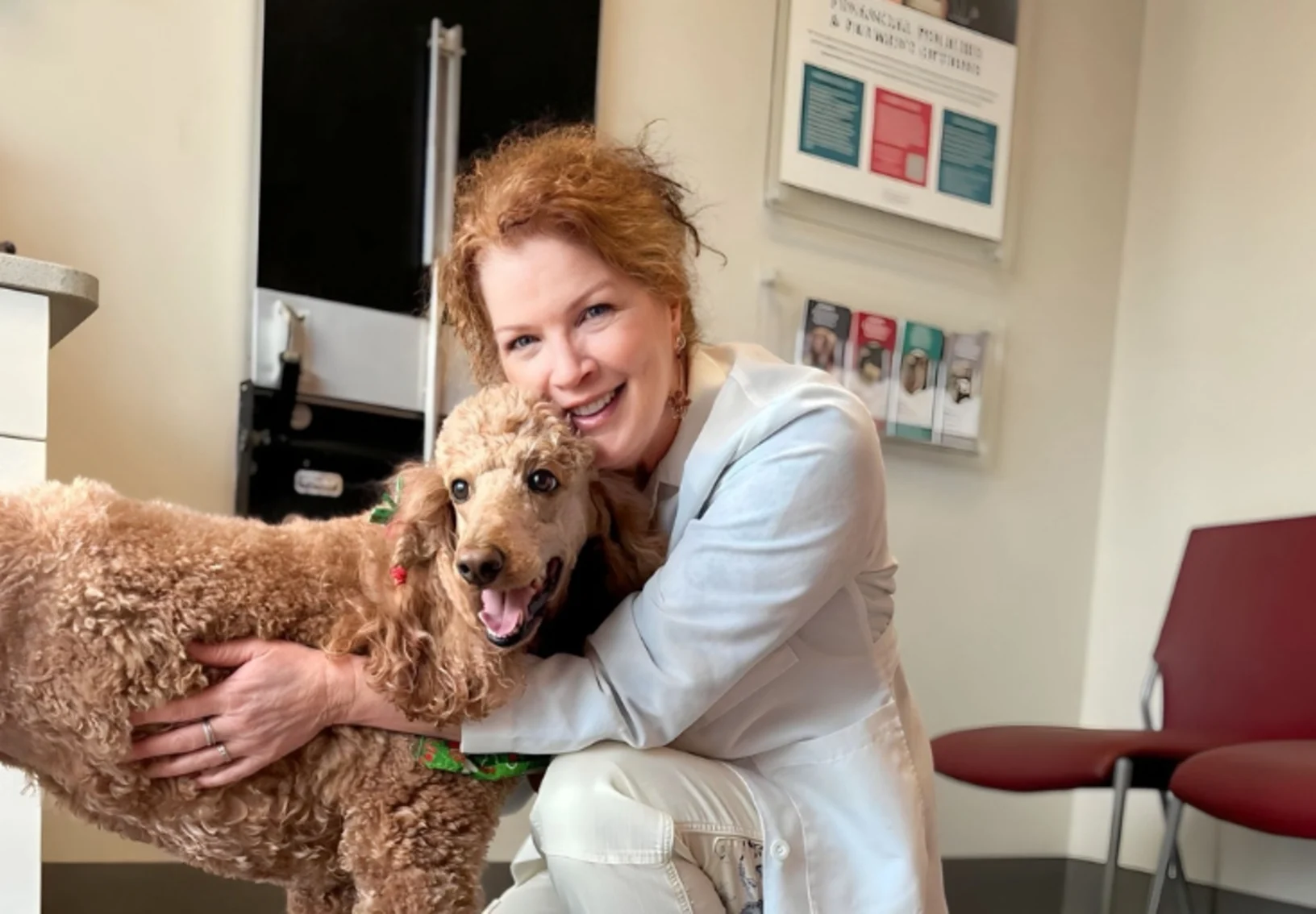 Dr. Weigt hugging a dog. Dr. Weigt hugging a dog.