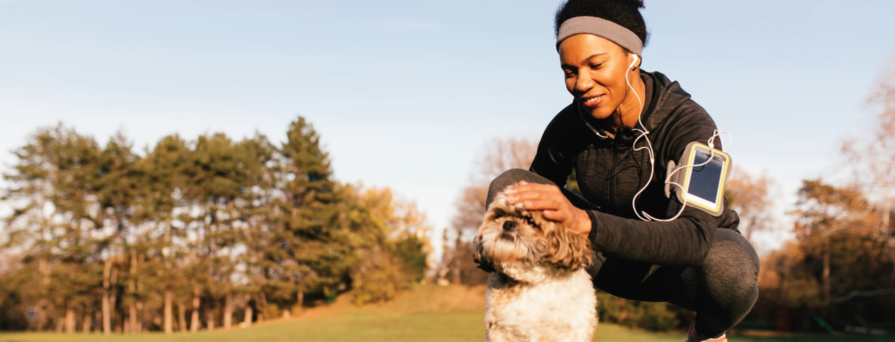 Active Woman with dog after a run in grass Active Woman with dog after a run in grass