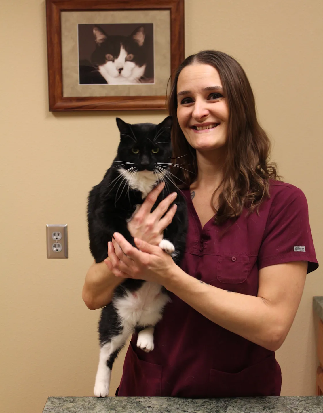 Becca at Dunes Animal Hospital, with black and white cat Becca at Dunes Animal Hospital, with black and white cat