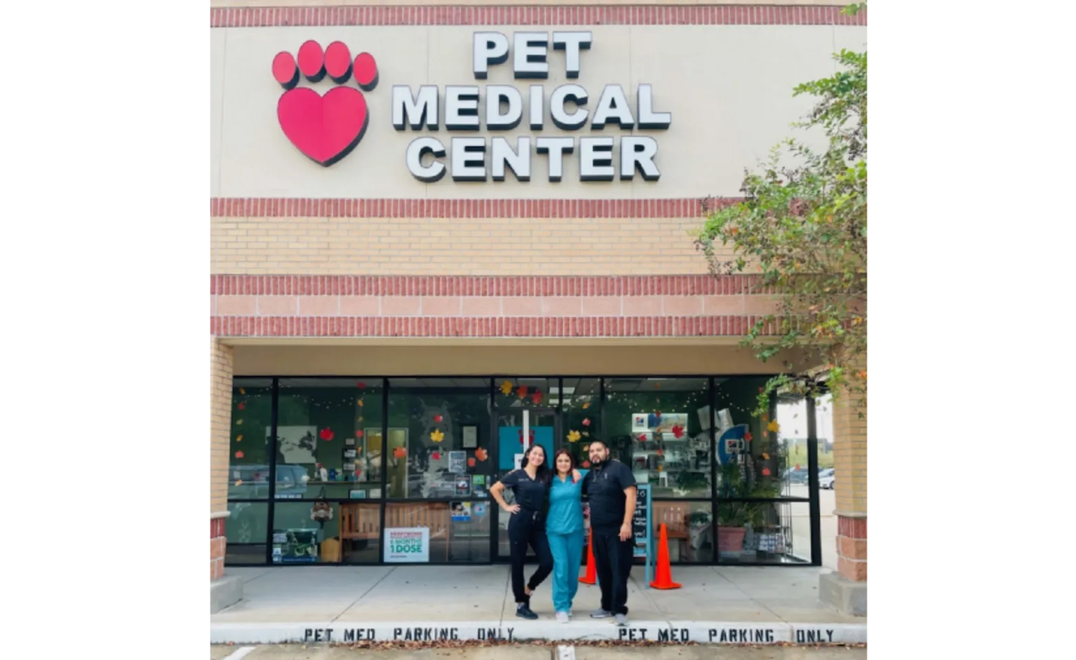 Front View of Building with 3 Staff Members in Front Standing Front View of Building with 3 Staff Members in Front Standing