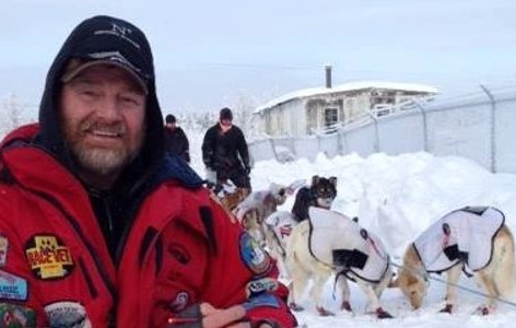 Staff in snow with dogs