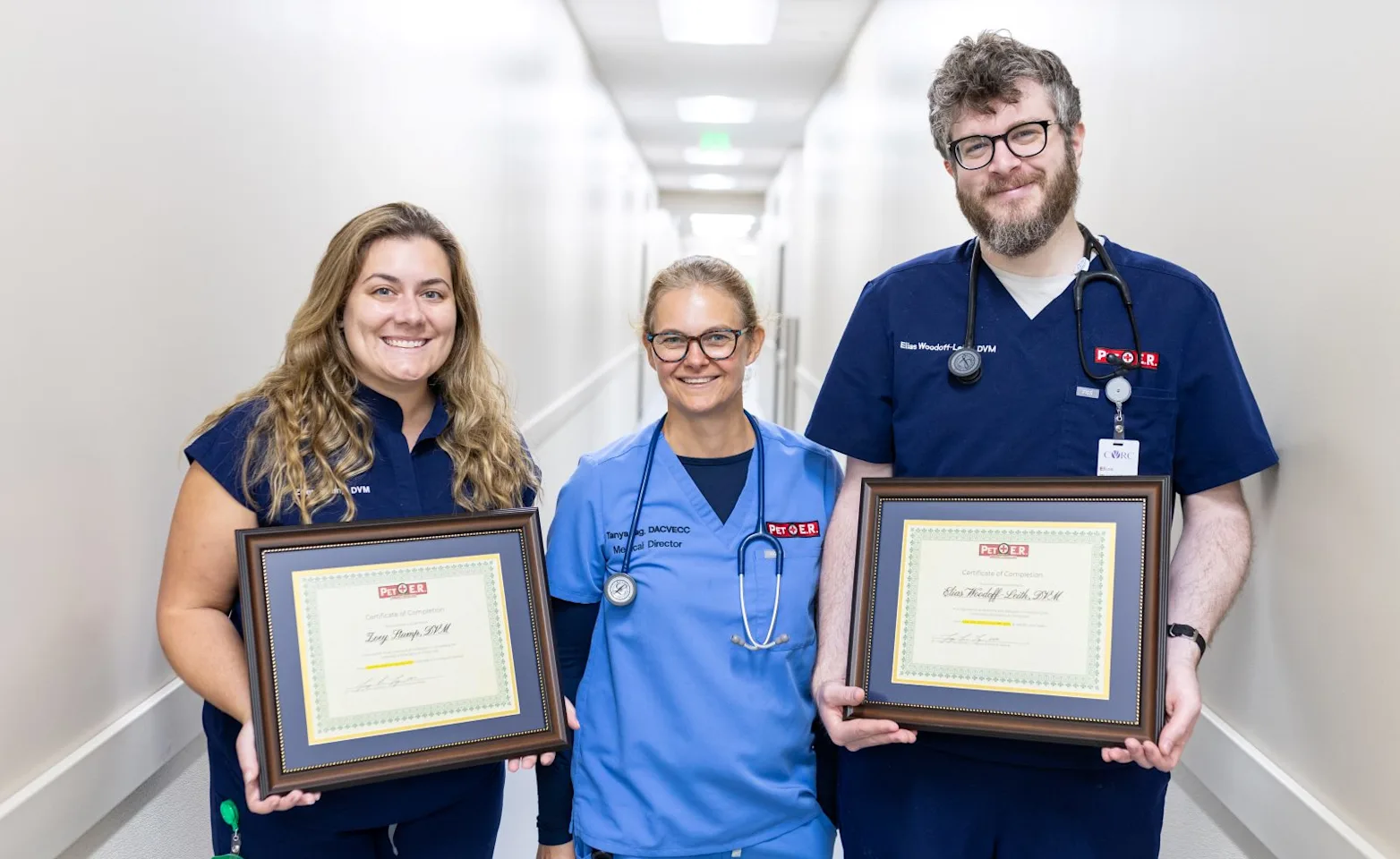 Vet and 2 interns holding certificates Vet and 2 interns holding certificates