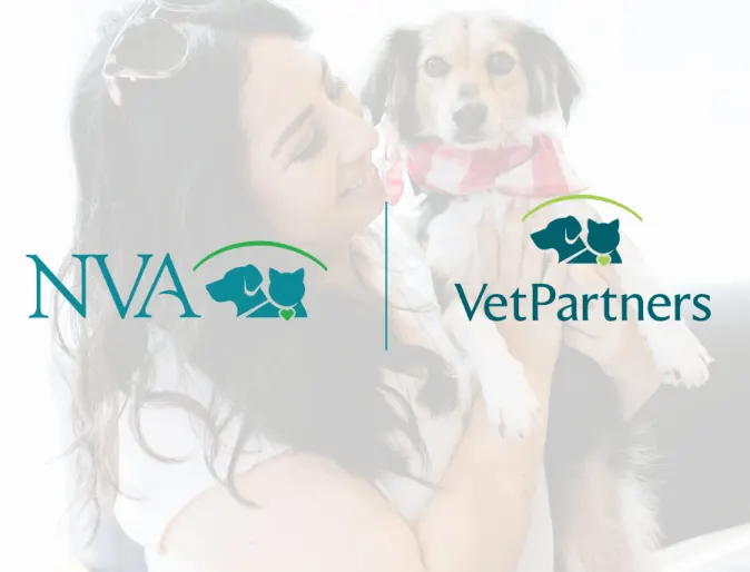 Woman holding a black and tan dog with NVA and VetPartners logo on top