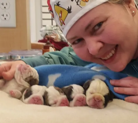 Staff member with puppies Staff member with puppies