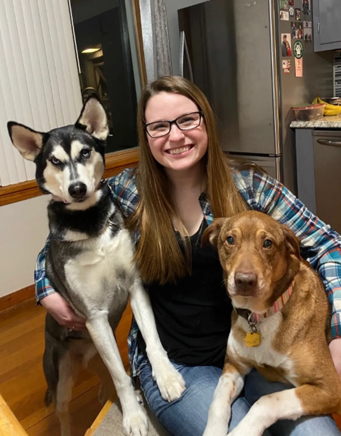 Tabatha sitting down holding two dogs Tabatha sitting down holding two dogs