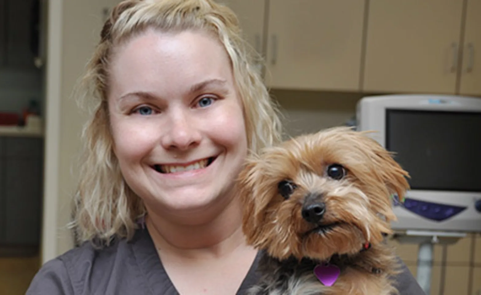 AECC staff holding small dog AECC staff holding small dog