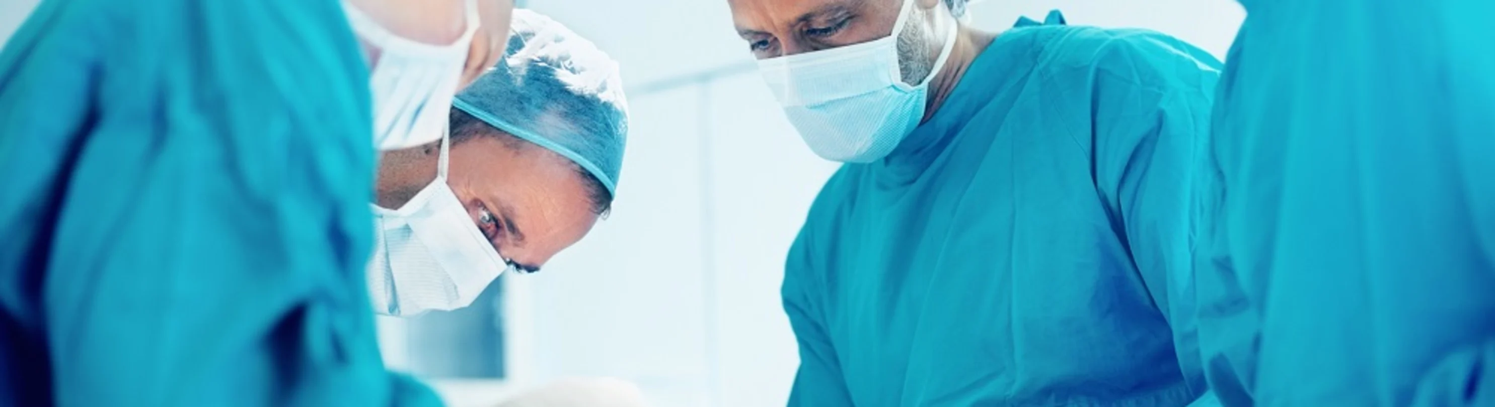 A group of doctors performing surgery A group of doctors performing surgery