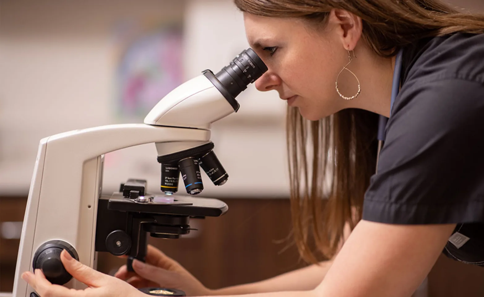 Dr. Howard looking through Microscope