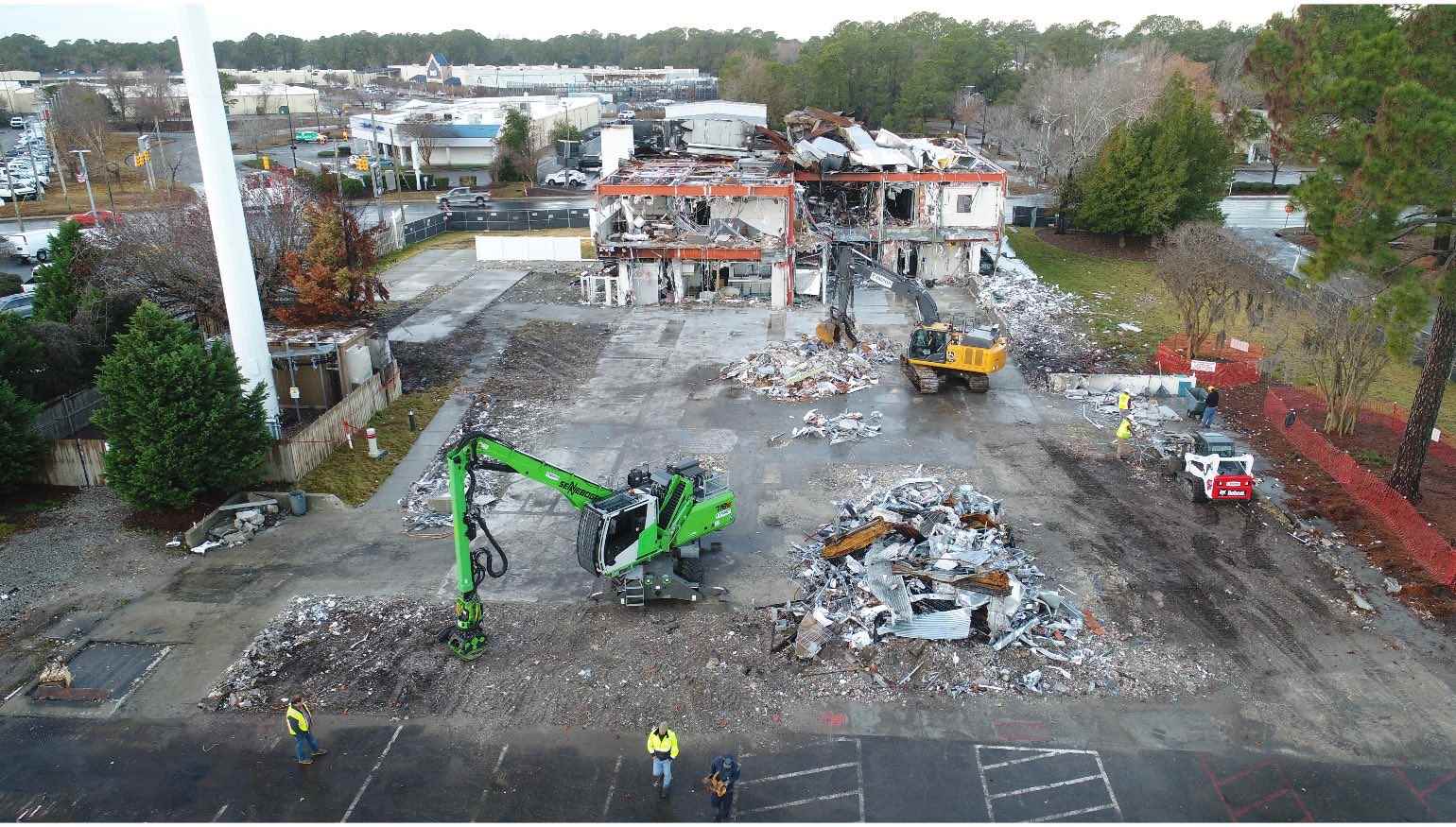 A demolition site with heavy machinery surrounding it.