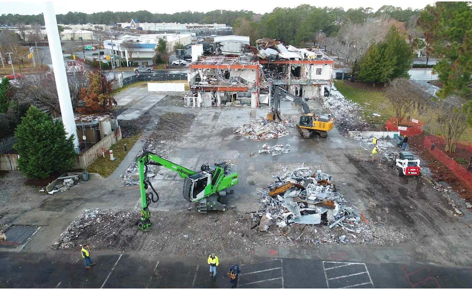 A demolition site with heavy machinery surrounding it. A demolition site with heavy machinery surrounding it.