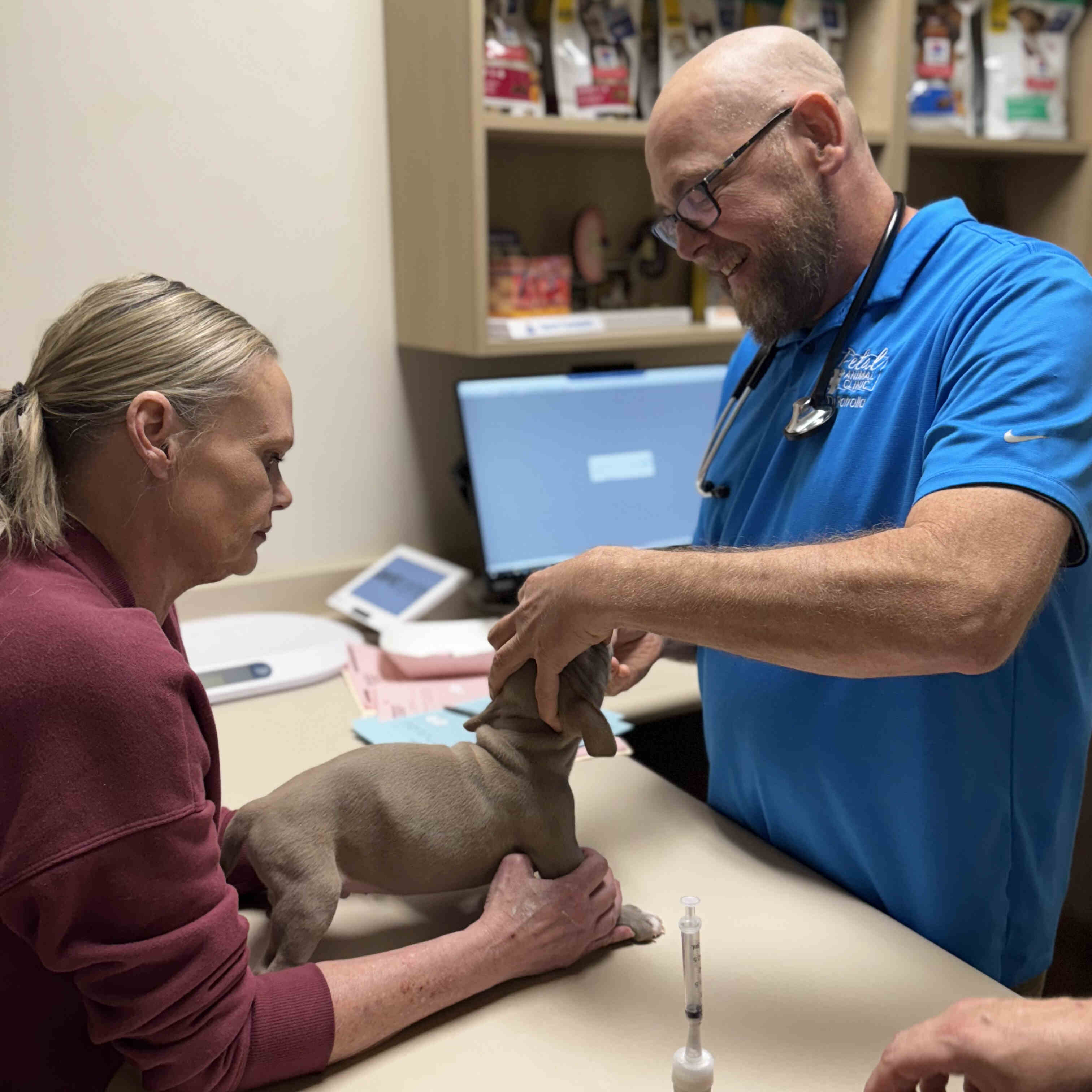 Dr. Patrolia Examining a Patient (Dog)