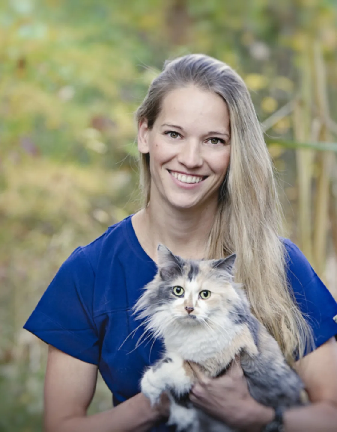 Dr. Franzi Ruder holding a calico cat Dr. Franzi Ruder holding a calico cat