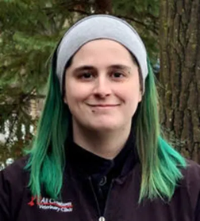 Victoria smiling standing outside in front of a tree