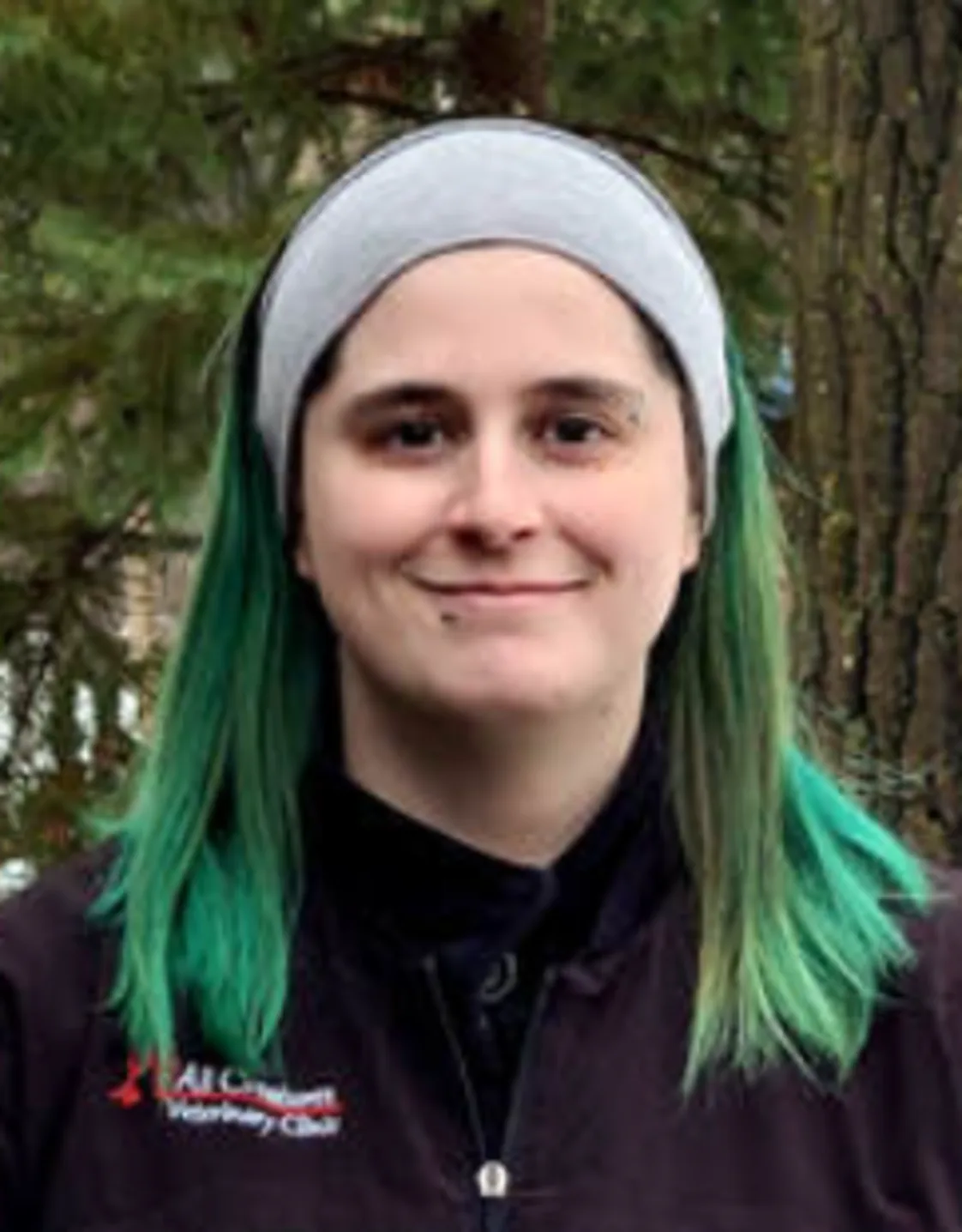 Victoria smiling standing outside in front of a tree Victoria smiling standing outside in front of a tree