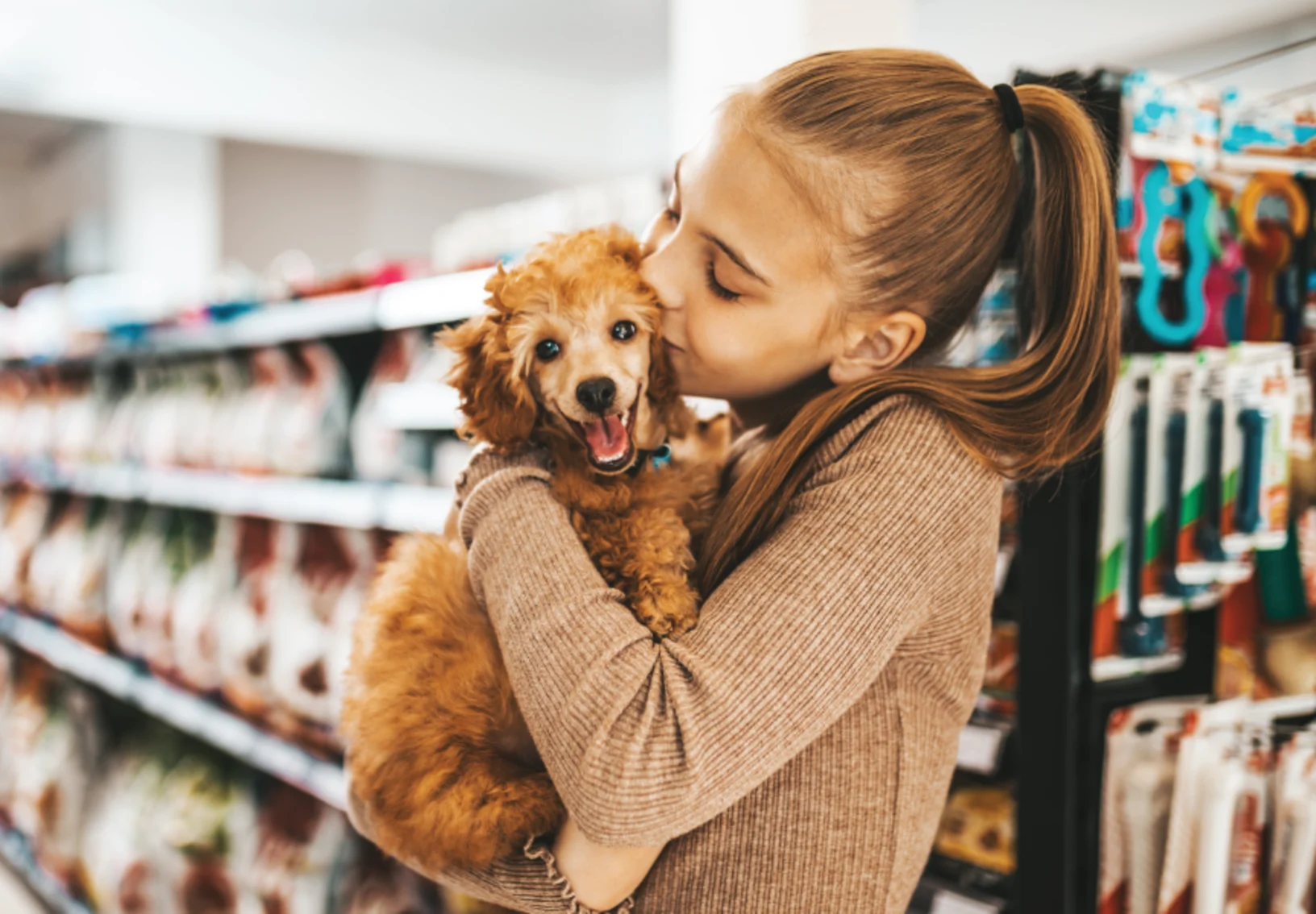 Girl kissing dog 