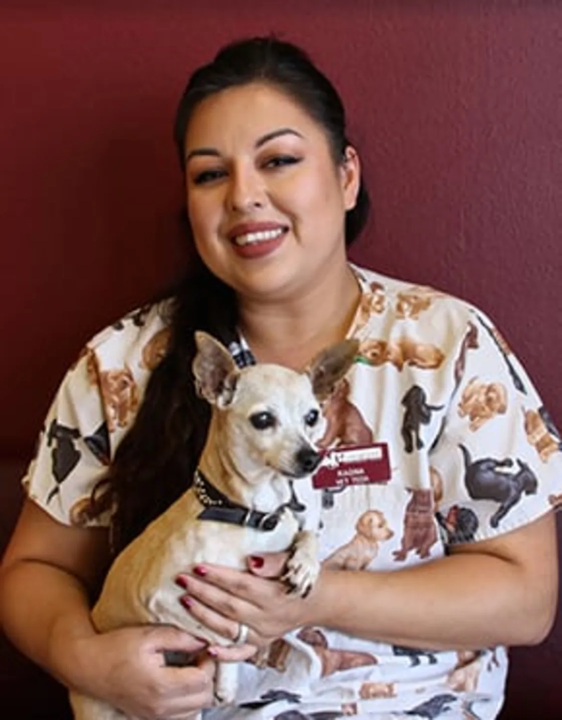 Ragina smiling while holding a dog Ragina smiling while holding a dog