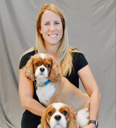 Dr. Marnie Duplissis sitting with two dogs Dr. Marnie Duplissis sitting with two dogs