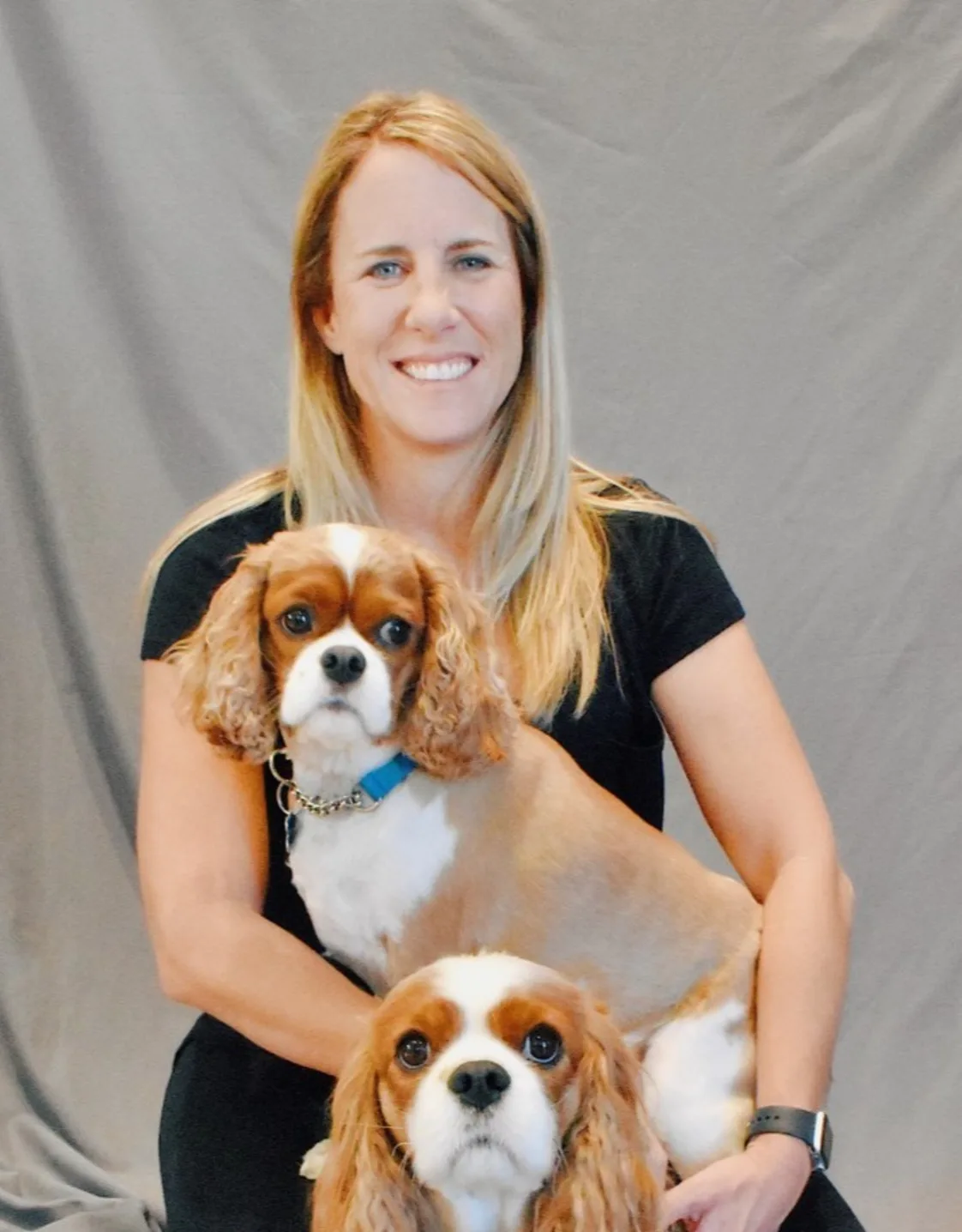 Dr. Marnie Duplissis sitting with two dogs Dr. Marnie Duplissis sitting with two dogs