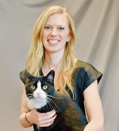 Dr. Sarah Nelson sitting with a cat Dr. Sarah Nelson sitting with a cat