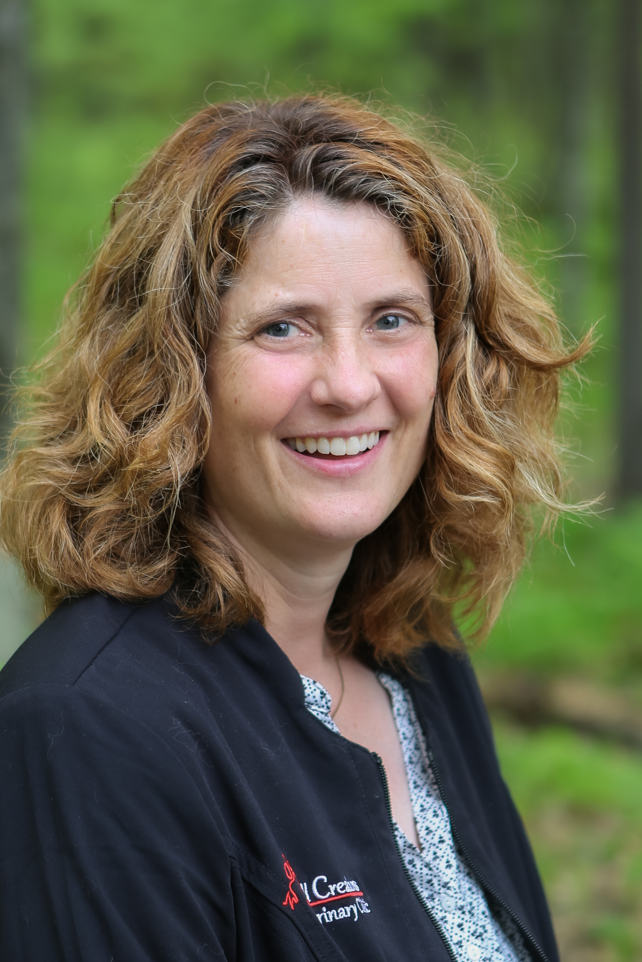 Janet smiling standing outside