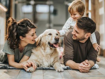 Family Laying on the Ground with Golden Retriever