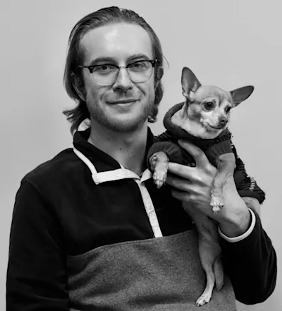 Brandon smiling while holding onto a chihuahua. Brandon smiling while holding onto a chihuahua.