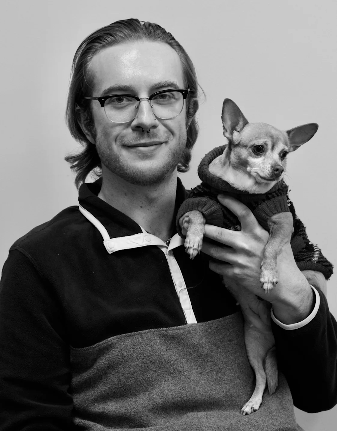 Brandon smiling while holding onto a chihuahua. Brandon smiling while holding onto a chihuahua.