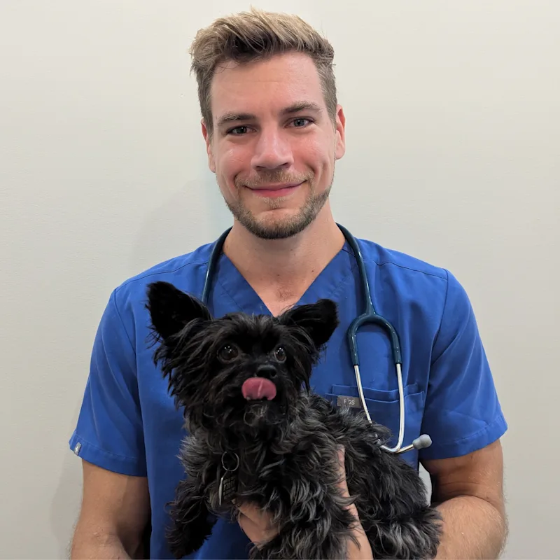 Dr. Nathan Schachtschneider with a green bird on his shoulder Dr. Nathan Schachtschneider with a green bird on his shoulder