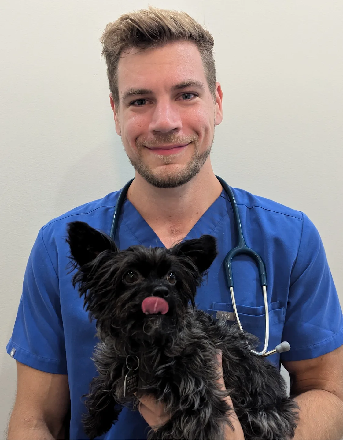 Dr. Nathan Schachtschneider with a green bird on his shoulder Dr. Nathan Schachtschneider with a green bird on his shoulder