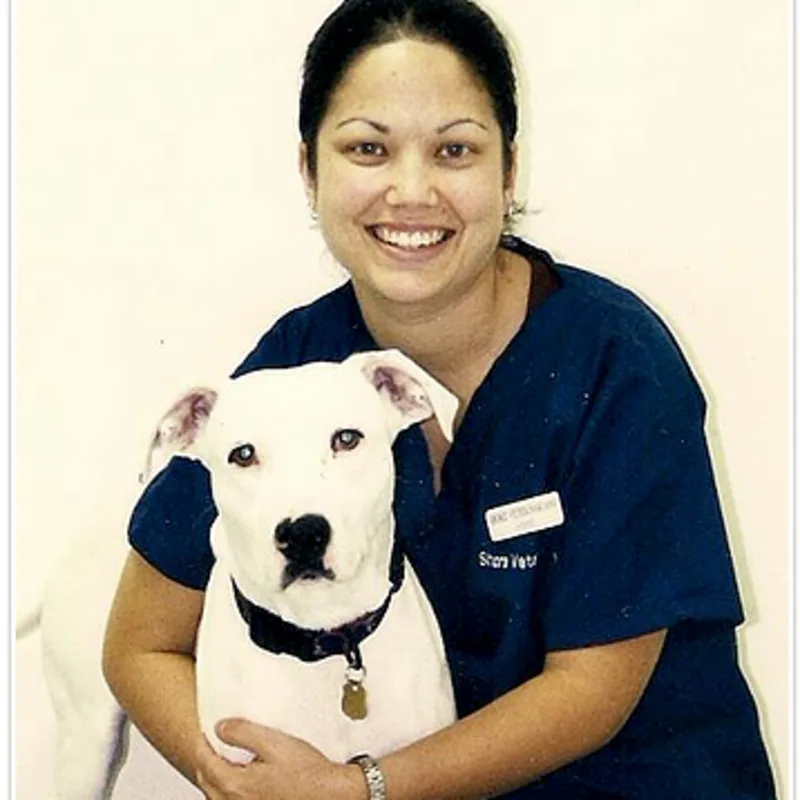 Dr. Moynahan with a white dog. Dr. Moynahan with a white dog.