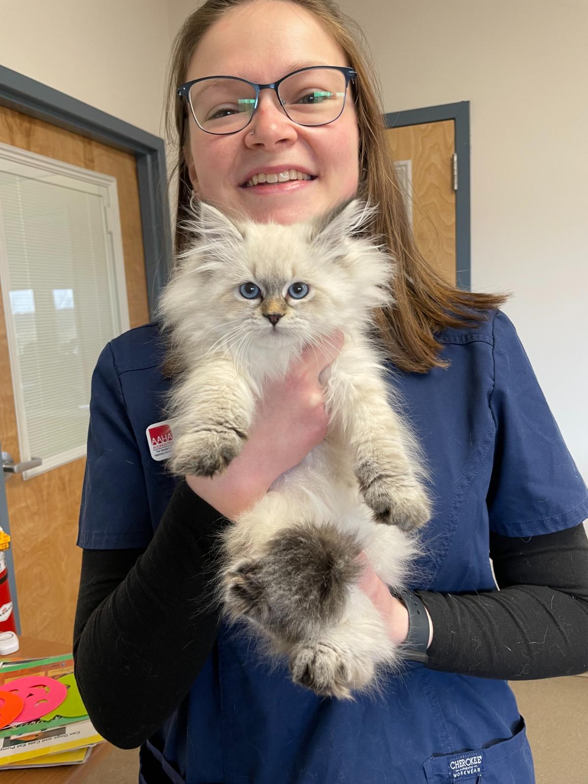 Emilie holding a white fluffy cat