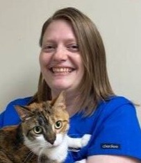 Melissa holding a brown and white cat