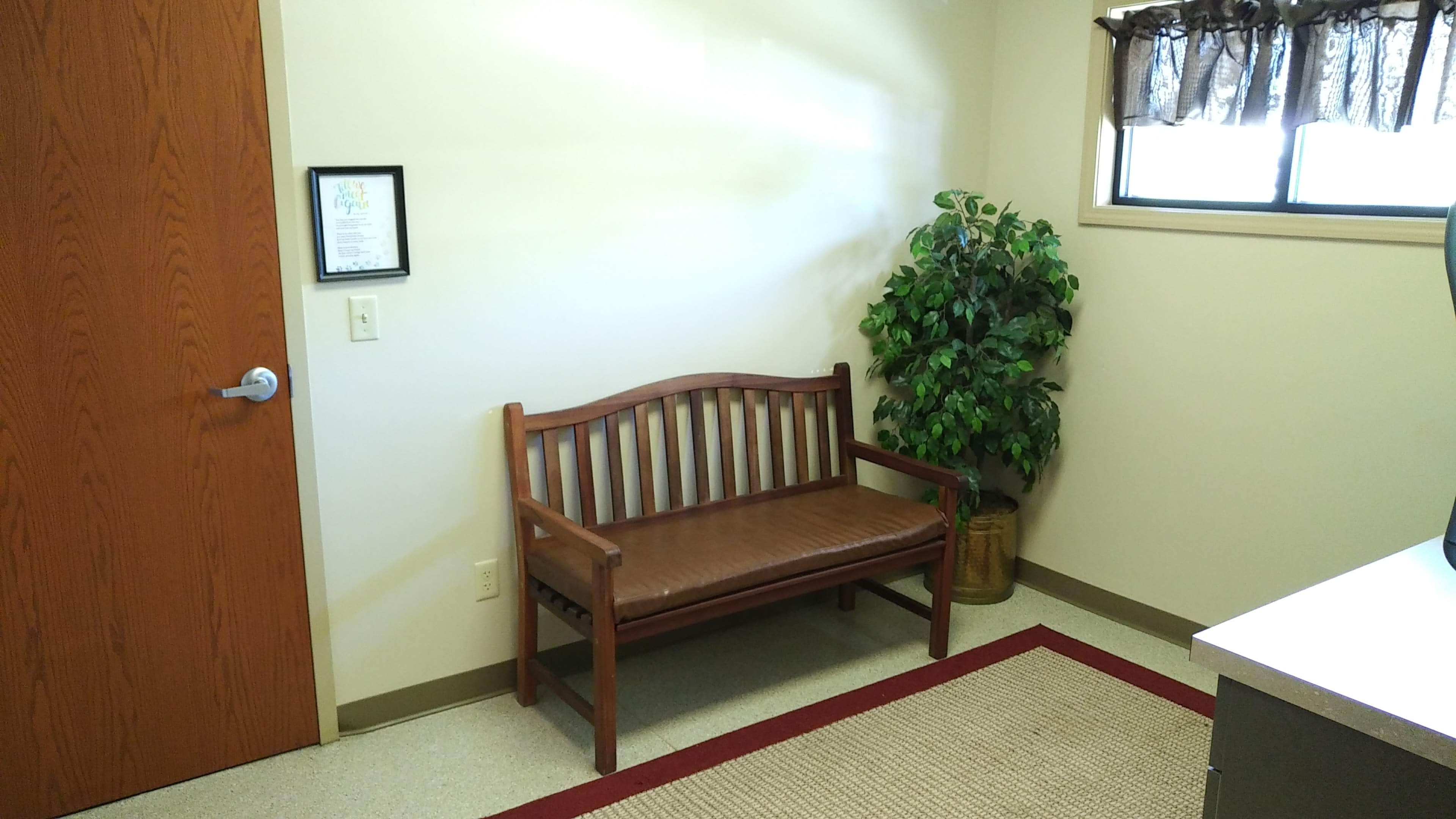 A bench inside of the reception area of the hospital