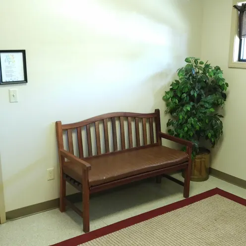 A bench inside of the reception area of the hospital
