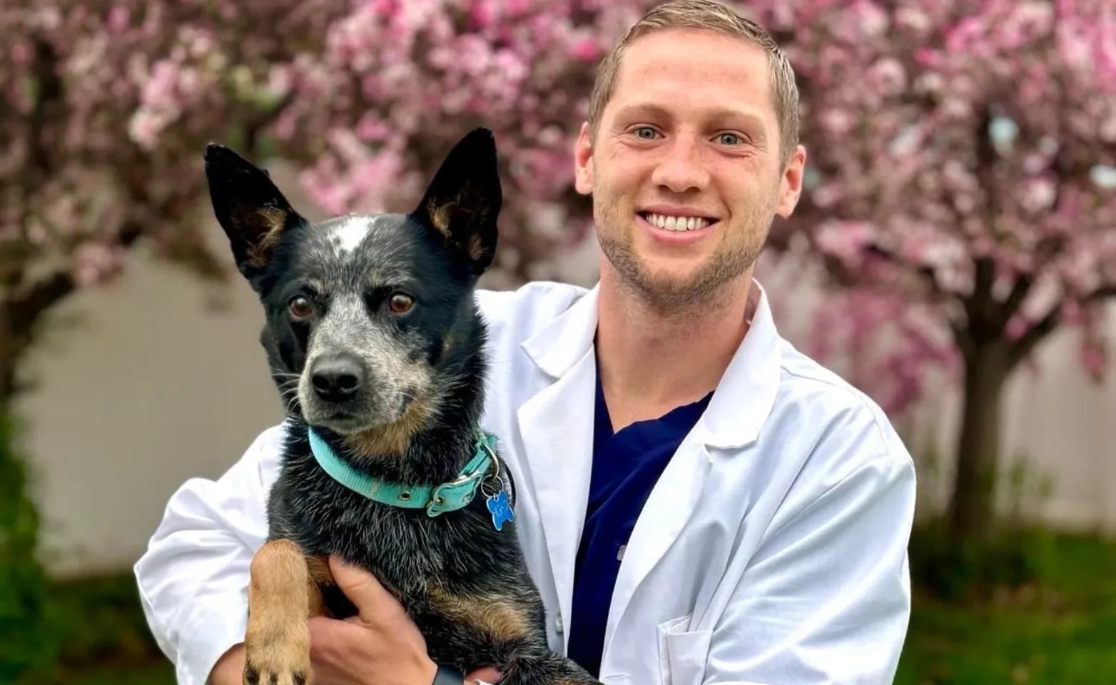 Dr. Jack Murray, Associate Veterinarian at Starch Animal Hospital holding a black dog Dr. Jack Murray, Associate Veterinarian at Starch Animal Hospital holding a black dog