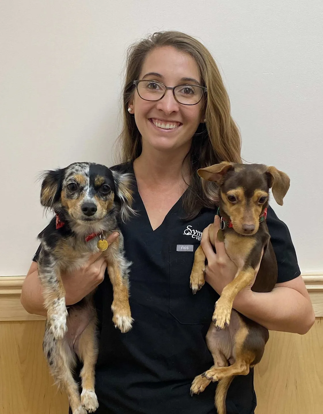 Dr. Elizabeth holding two small dogs. Dr. Elizabeth holding two small dogs.