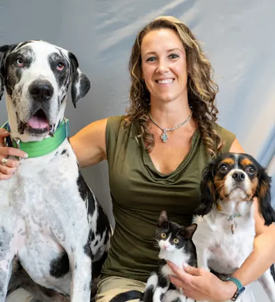 Caroline sitting with two dogs Caroline sitting with two dogs