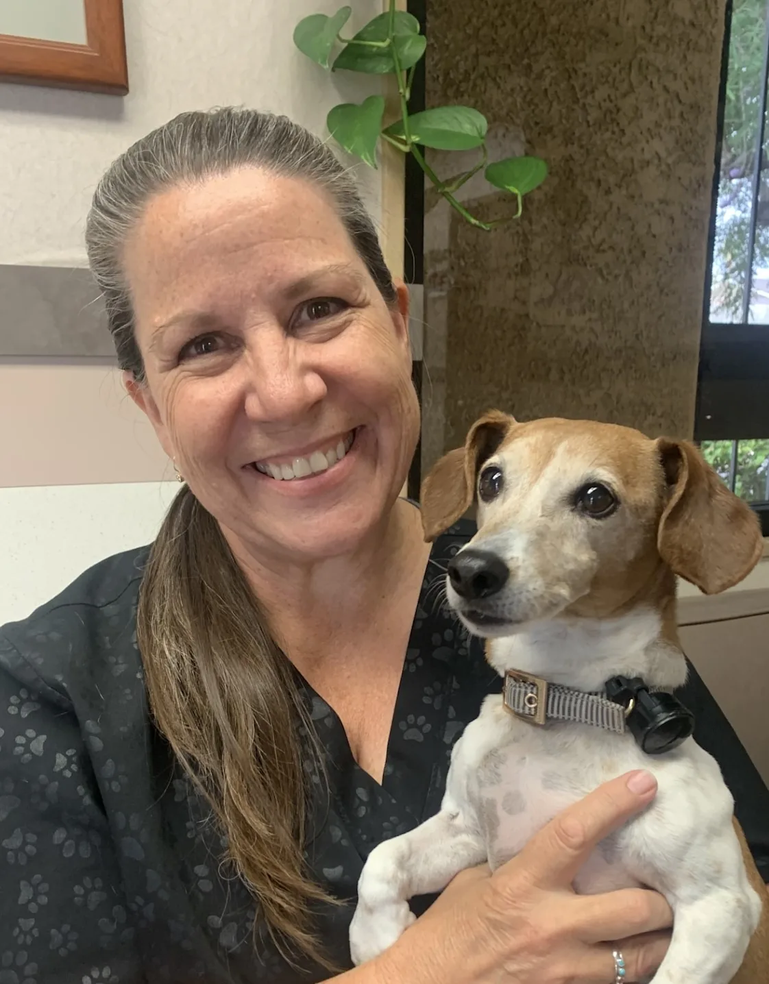 Debra Cortez with small dog on her lap Debra Cortez with small dog on her lap