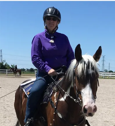 A photo of Lynn Bradt riding a horse