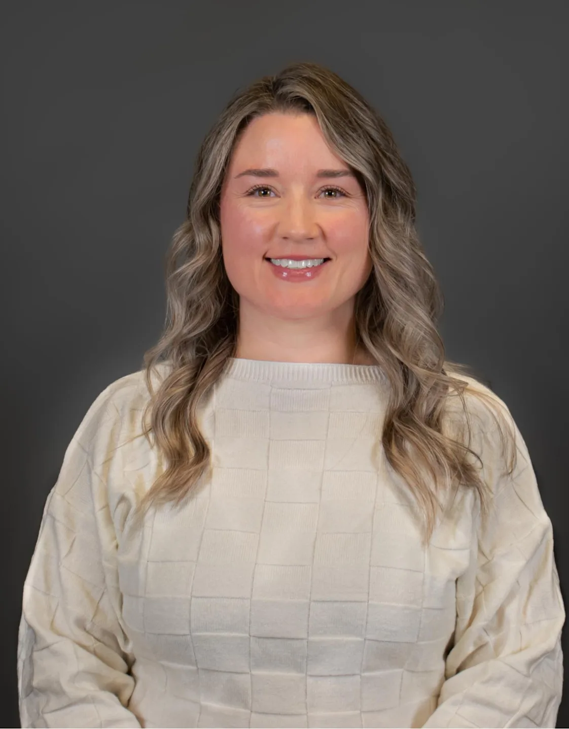 Kathryn McCutcheon holding two black and brown dogs, with the one one her left wearing a blue bandana and the one on the right wearing a pink flower on its neck. Kathryn McCutcheon holding two black and brown dogs, with the one one her left wearing a blue bandana and the one on the right wearing a pink flower on its neck.