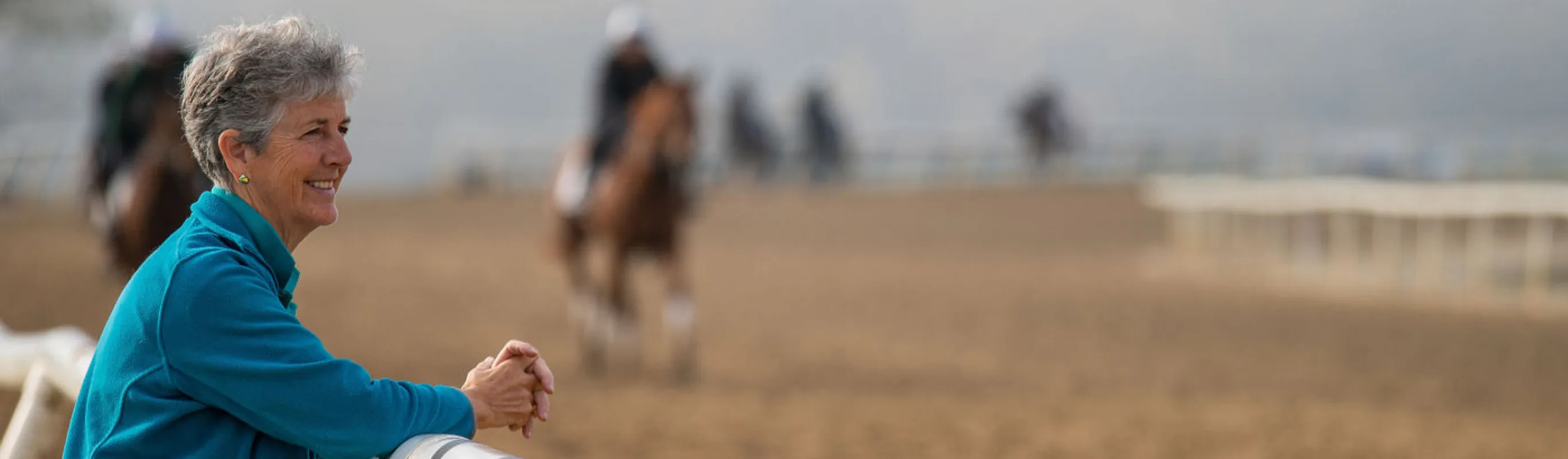 Veterinarian watching horses on a track Veterinarian watching horses on a track