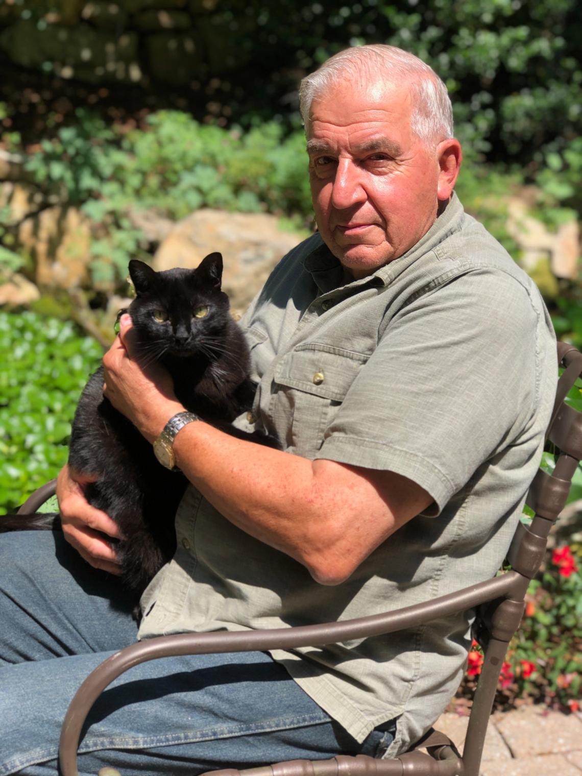 Doc holding a black cat
