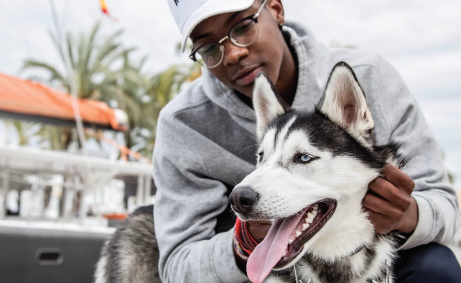 Man holding dog on boat dock Man holding dog on boat dock