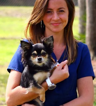 Jessica H. holding dog outside