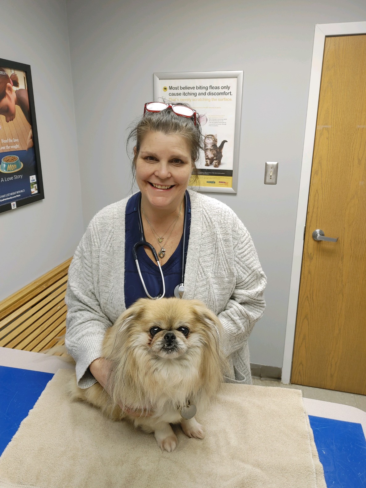 Dr. Kopilak Smiling with a fluffy dog